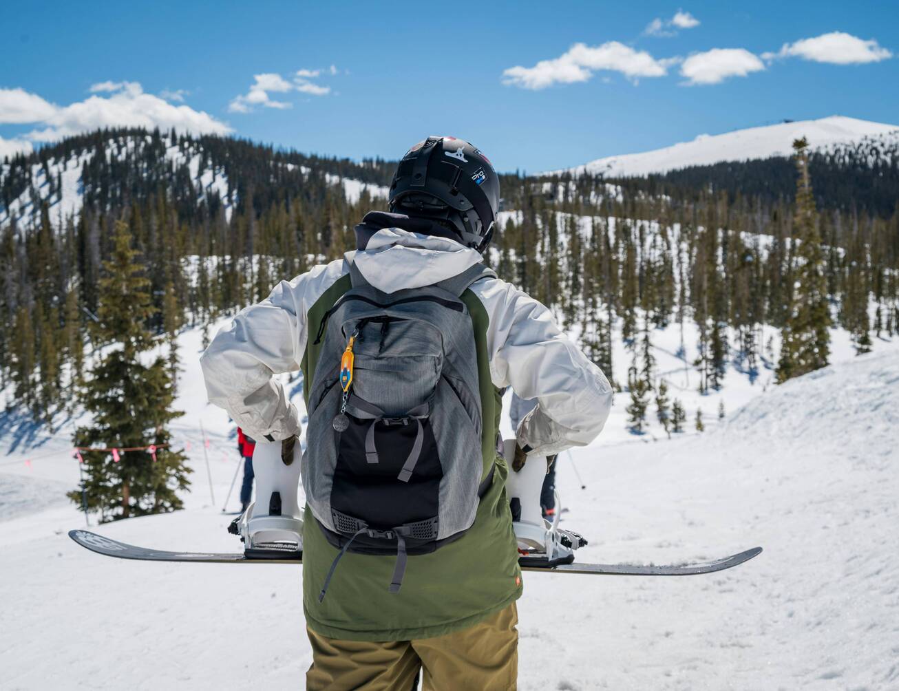 Custom hiking backpack used by a hiker in a snowy mountain outdoor travel scene